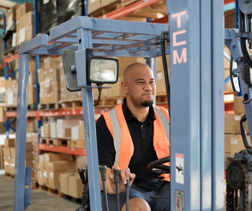 Forklift operator moving stock in a distribution warehouse